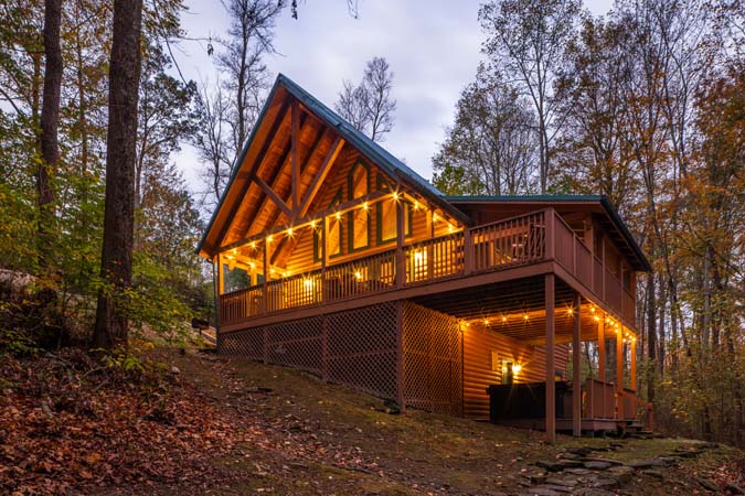 Screened porch overlooking woods at Cardinal Cabin