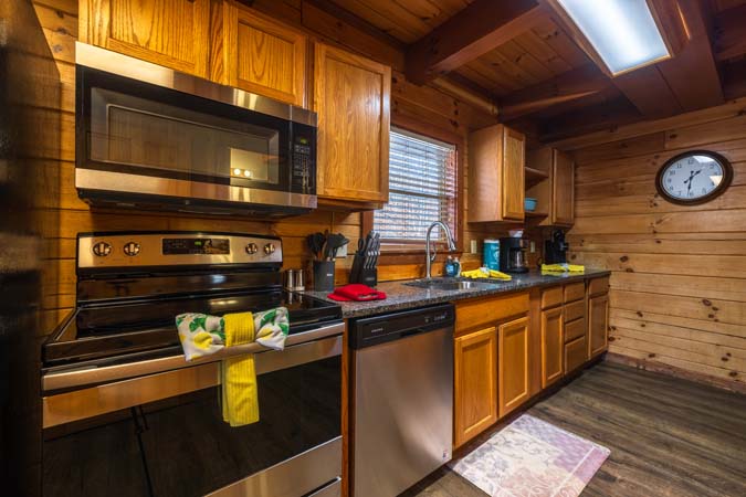 Rec room queen bed at Chickadee Cabin