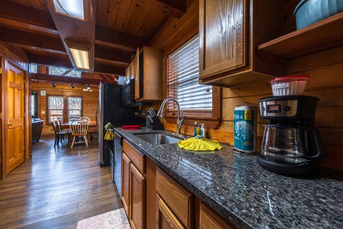 Loft sleeping area with two queen beds at Chickadee Cabin