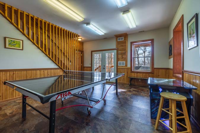 Multiple decks overlooking woods at Chickadee Cabin