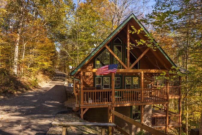 Outdoor hot tub surrounded by trees at Chickadee Cabin