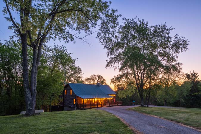 Green Acres Lodge evening exterior with surrounding forest views