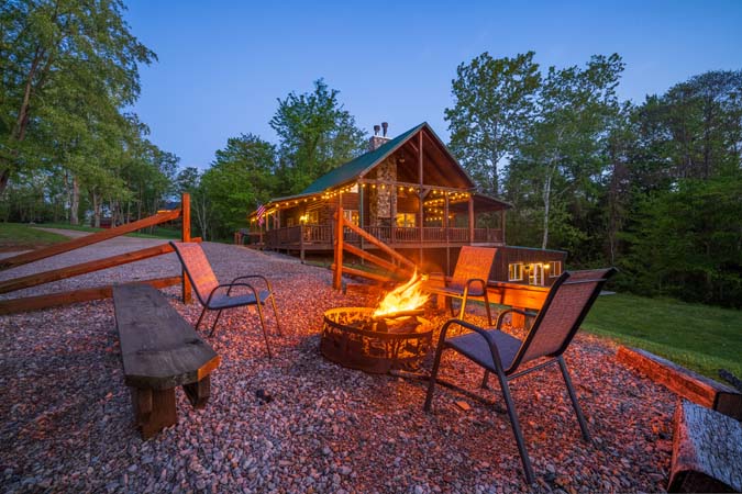 Luxury lodge exterior at dusk with warm lighting