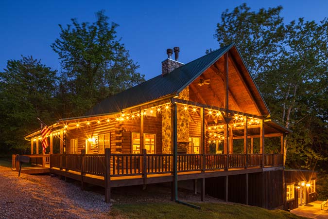 Twilight view of Green Acres Lodge with outdoor fireplace area