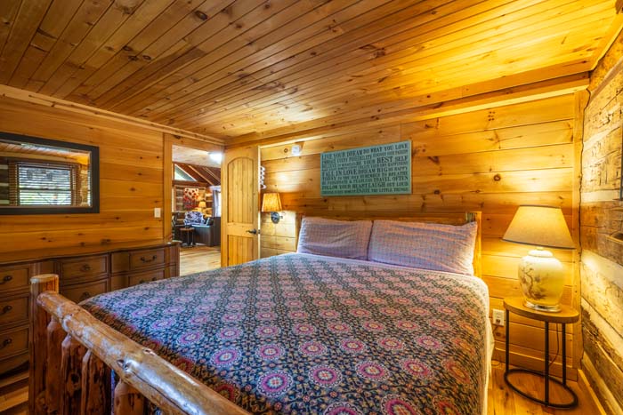 King bedroom with rustic log furniture