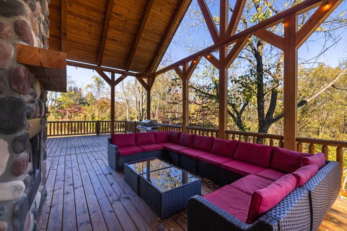 Covered deck seating under a timber-frame ceiling