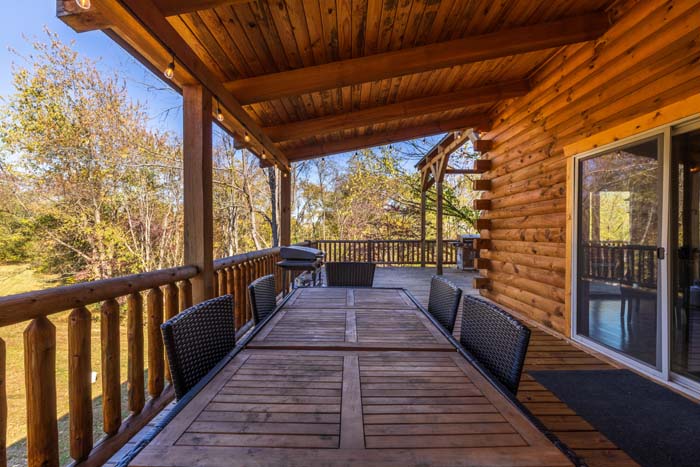 Covered deck dining table for six with wicker chairs