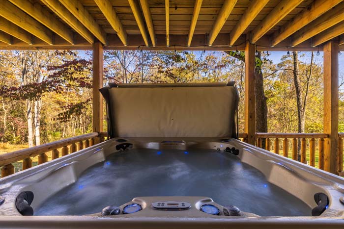 Hot tub on the covered deck with woodland views