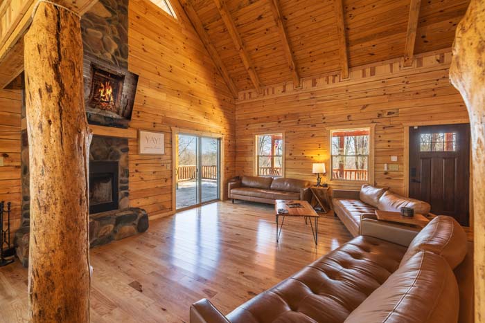 Great room with stone fireplace and hardwood floors