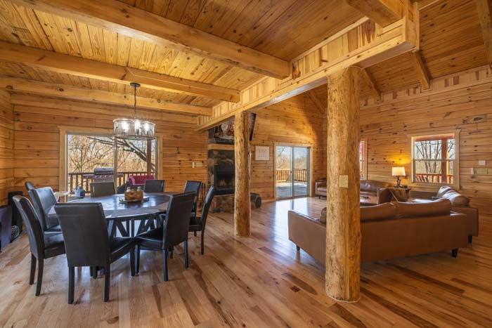 Open dining and living area with log posts