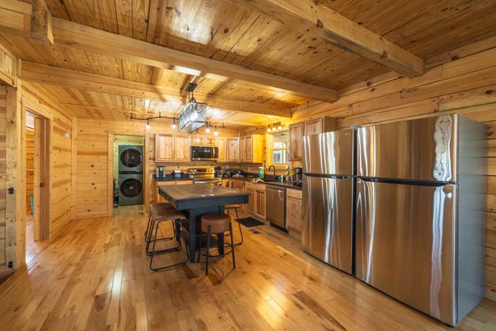 Kitchen with island seating and stacked laundry