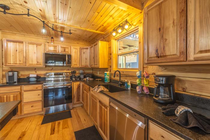 Hickory kitchen with black counters and range