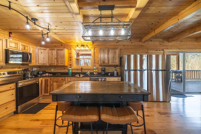 Spacious kitchen with pendant lights and dining area