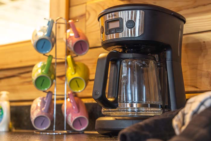 Coffee maker with colorful mugs