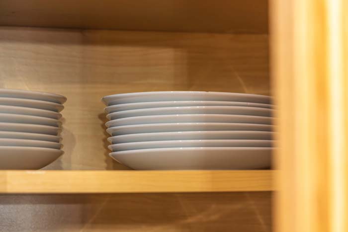 Stacked plates and bowls in the cabinet