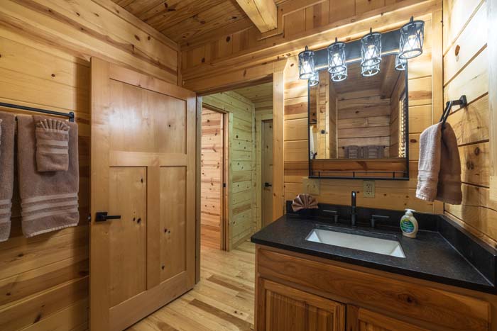 Bathroom vanity with black granite and lantern lights