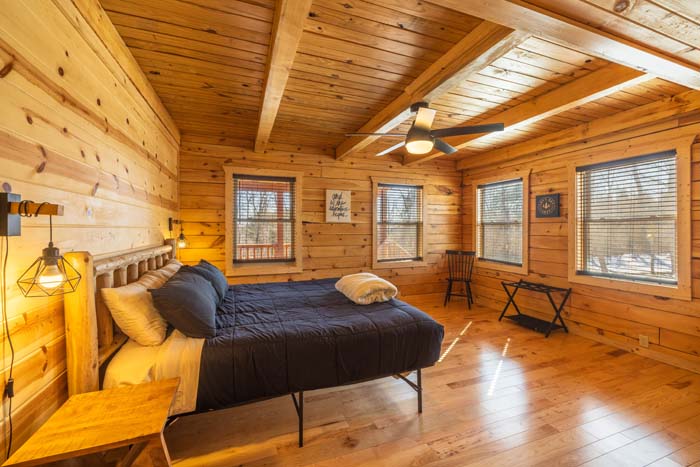 Bedroom with king log bed and skylight