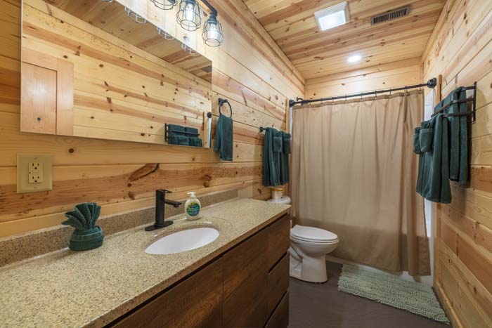 Bathroom with vanity, toilet, and tub-shower