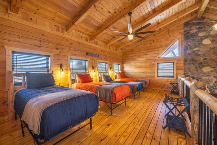 Loft bunk room with three beds