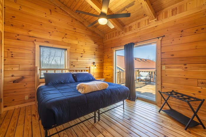 Bedroom with king bed and deck view of the barn