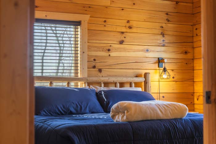 King bed with wall lamps and window