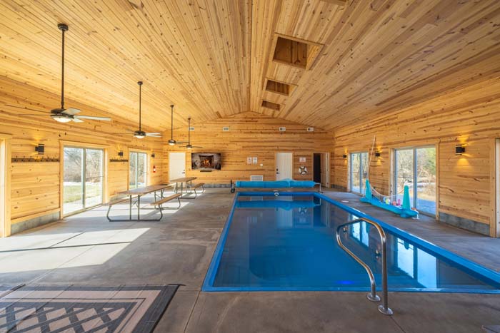 Indoor pool house with heated pool and TV