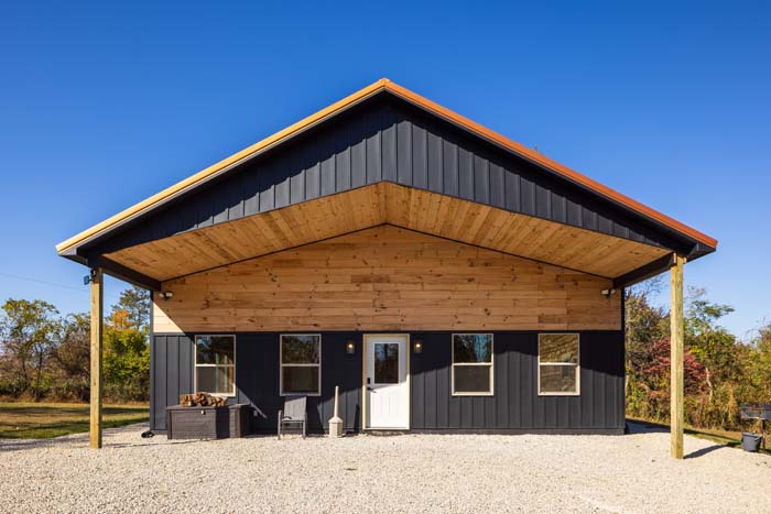 Black game barn with covered porch at Highland Lodge