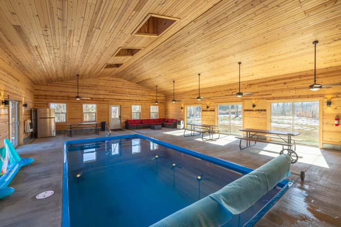 Indoor pool house with seating and picnic tables
