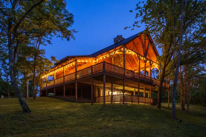 Highland Lodge front gable lit at dusk