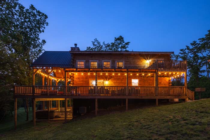 Hot tub glowing at dusk on the covered deck