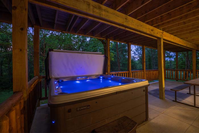 Fire pit at dusk with sunset sky, barn, and lodge