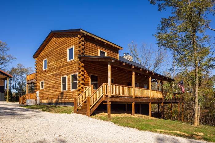 Log cabin side entry with covered porch and steps