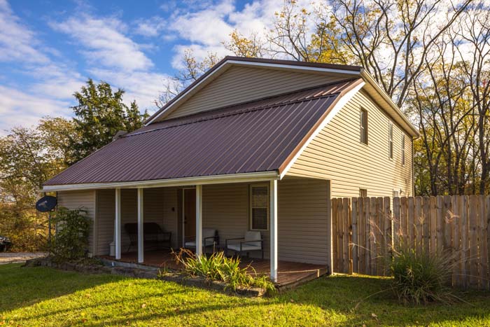 Hiker's Hideout cottage exterior with covered porch and metal roof