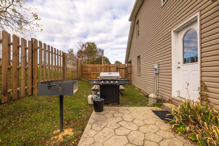 Side yard with gas and charcoal grills
