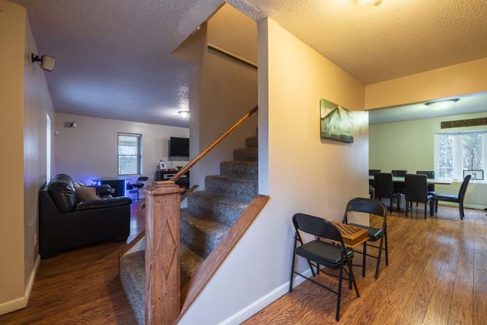 Entry with staircase, game table, and dining area