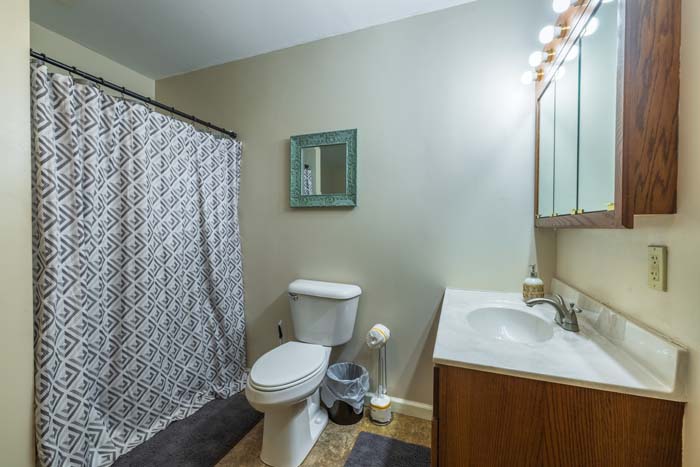 Bathroom with patterned shower curtain and vanity