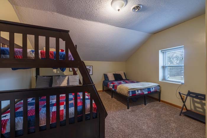 Bedroom with bunk bed and twin bed in Americana quilts