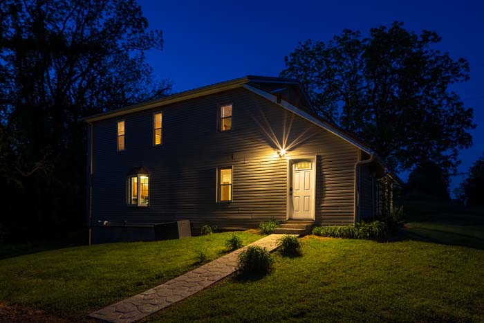 Hiker's Hideout exterior illuminated at dusk
