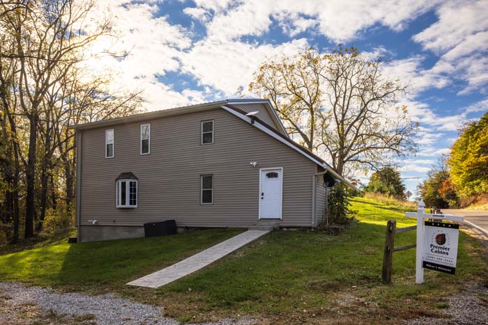 Rear exterior with Premier Cabins sign and walkway