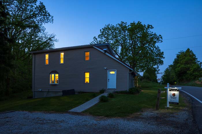 Exterior at dusk with Premier Cabins sign
