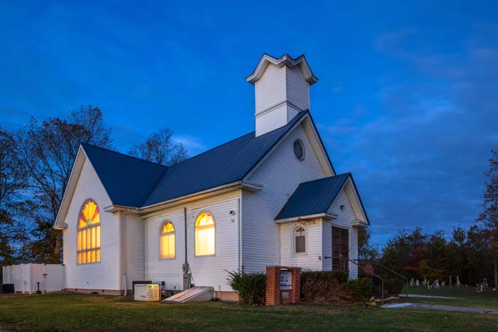 Outdoor gathering space with Adirondack chairs and fire pit