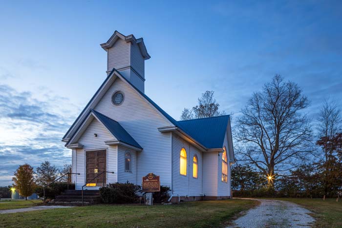 Main great room with open ceiling and large windows at Dragonfly Inn
