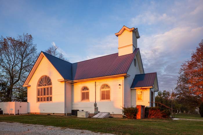 Dining area and living space under vaulted church ceiling