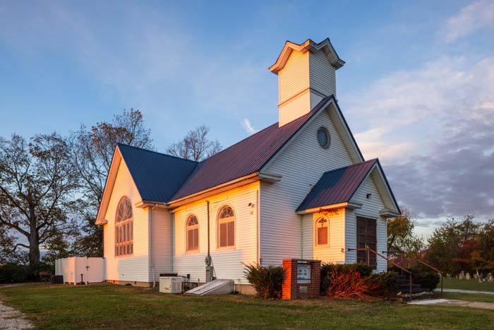 King bedroom with neutral tones and luxury linens at Dragonfly Inn