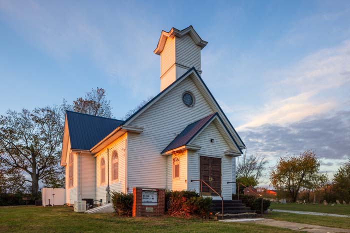 Bedroom featuring LOVE wall décor and warm lighting
