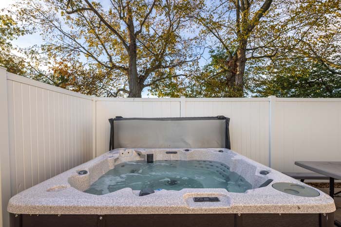 Fire pit area with multiple chairs under open sky