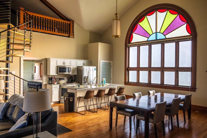 Bright kitchen area with stainless appliances and subway tile