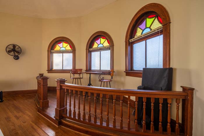 Game area with foosball and ping pong tables in great room