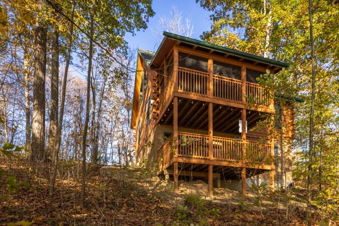 Living room with stone fireplace at Mockingbird Cabin