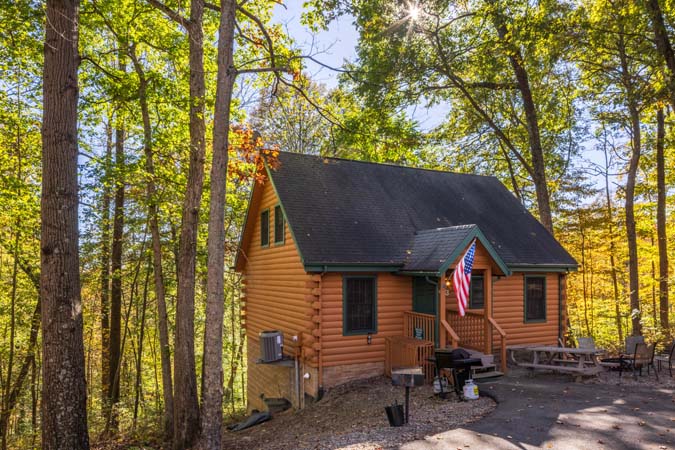 Screened porch overlooking woods at Mockingbird Cabin